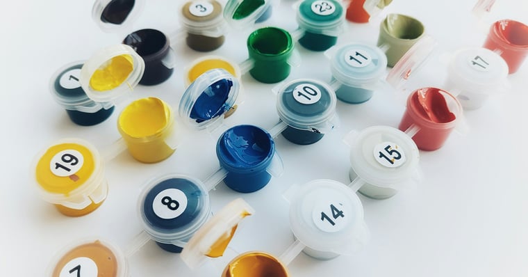 A collection of numbered paint containers.