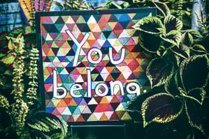 Art (photo credit to Tim Mossholder) stating "you belong," evoking a sense of inclusion.