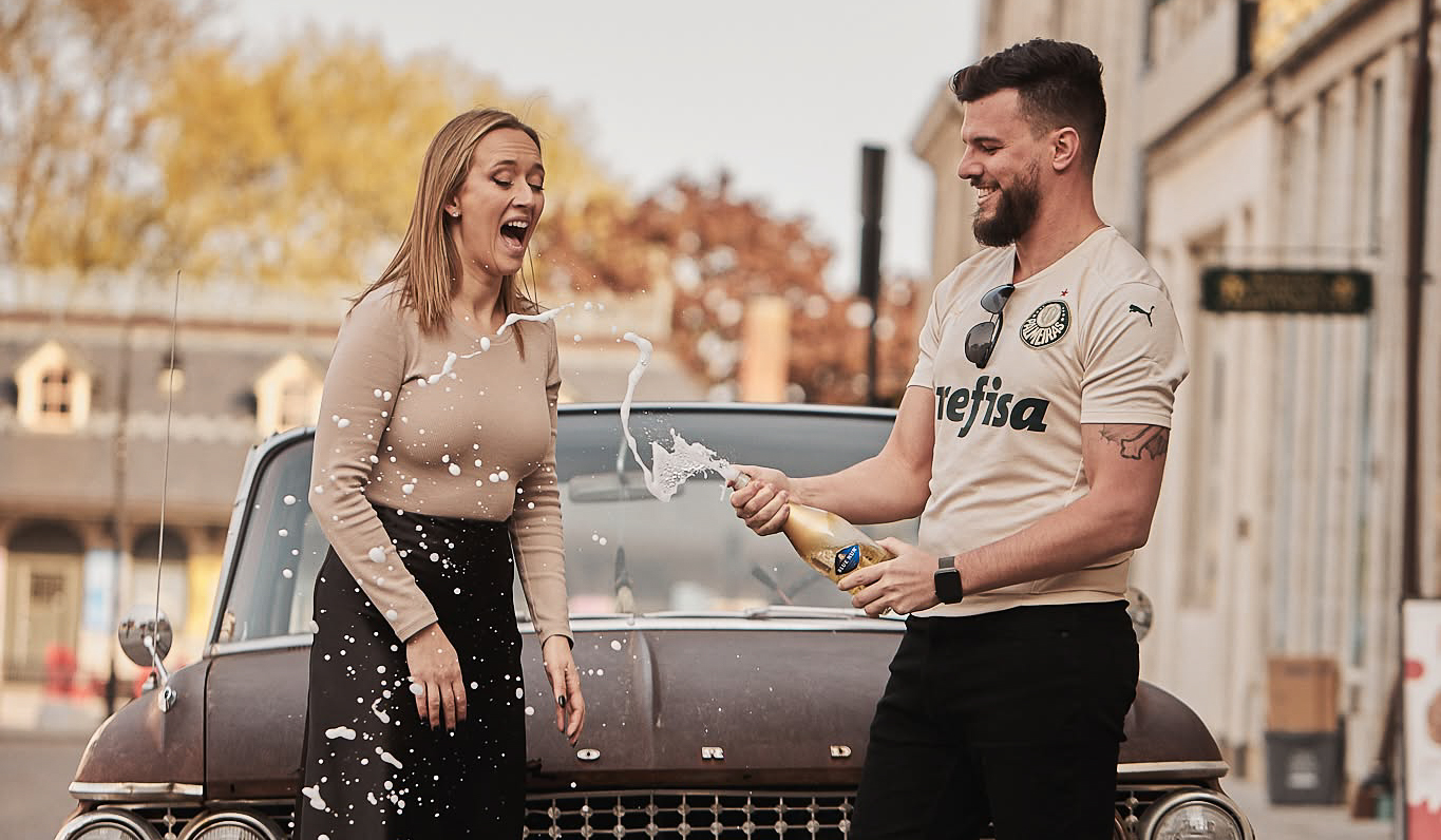 A couple celebrates their engagement by posing for a picture taken by  a local Kingston Wedding Photographer from the Happy Studios Team.